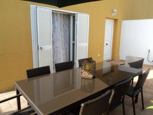 a dining room with a table with chairs and a window at Casa Tartessos in Costa Ballena