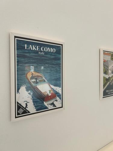 a poster of a boat on a wall at Lake Home Apartments in Lipomo