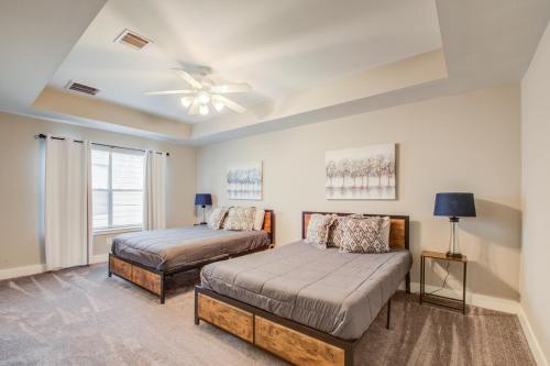 a bedroom with two beds and a ceiling fan at Upscale Retreat Near NRG/Med Ctr in Houston