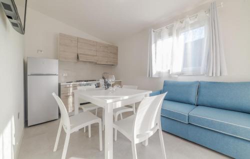 a kitchen with a white table and a blue couch at Gorgeous Home In Deiva Marina With Wifi in Deiva Marina