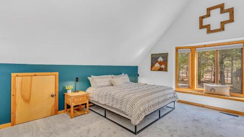 a bedroom with a bed and a cross on the wall at Circle 4 Cabin - Unit 2 in Bend