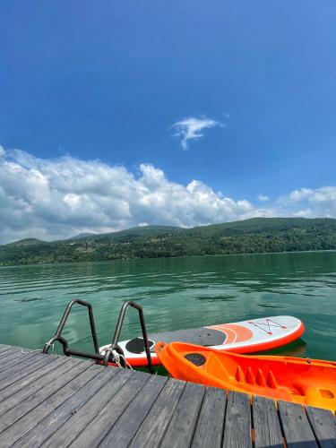 an orange kayak sitting on a dock on a lake at Splav ANDJELA Perucac in Perućac