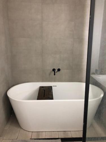 a white bath tub in a bathroom at Beach Flat Lytham St Annes in Lytham St Annes