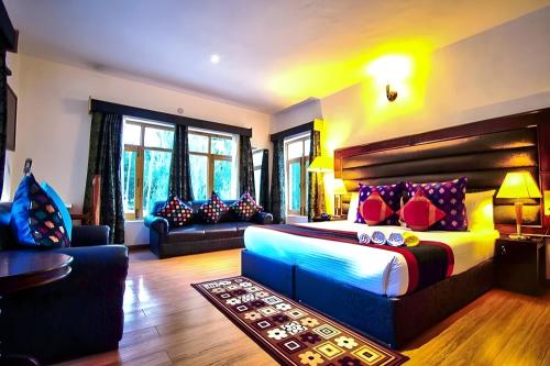 a bedroom with a large bed and a couch at Gomang Boutique Hotel in Leh