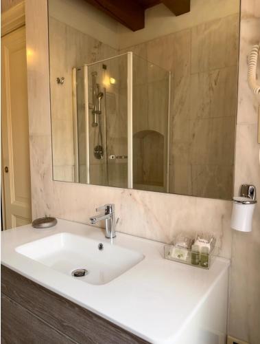 a bathroom with a sink and a mirror at Relais Ponte Pietra in Verona