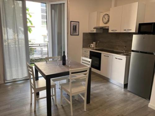 a kitchen with a table and chairs and a refrigerator at Emma House in Bellano