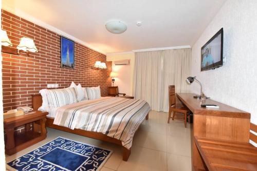 Postel nebo postele na pokoji v ubytování Grand Hôtel Aéroport, Douala