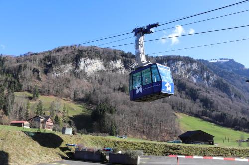 a gondola is flying over a mountain at Pilgerhaus Maria-Rickenbach - Anreise nur via Luftseilbahn möglich in Dallenwil