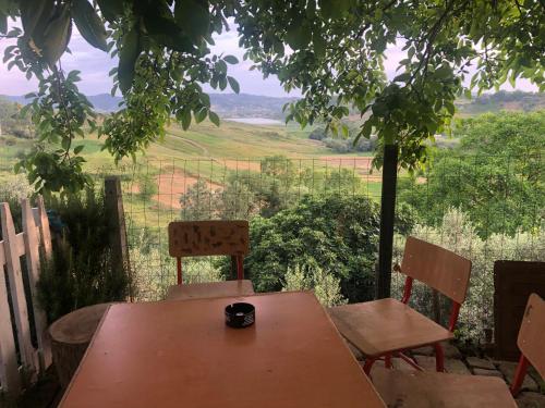 a table and chairs with a view of a field at Guest-house Grandfatherfarm1 in Durrës