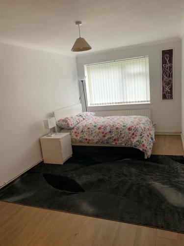 a bedroom with a bed and a window at 1 Bedroom Flat Apartment Bromley in Bromley