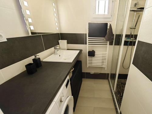 une salle de bain avec un lavabo et une machine à laver dans l'établissement T3 en Rez-de-Jardin avec Piscine, Parking, Clim et Proche Mer à Agde - FR-1-607-58, au Cap d'Agde