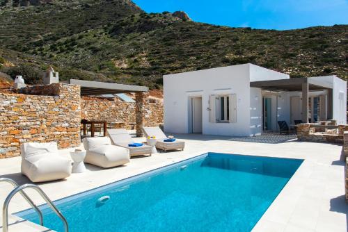 a villa with a swimming pool and a house at Filadaki Villas in Kamares