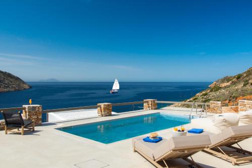 a swimming pool with a view of the ocean at Filadaki Villas in Kamares