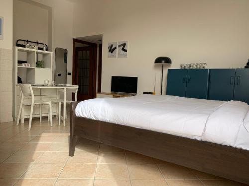 a bedroom with a bed and a table and a dining room at Appartamento Baia del Re - Navigli in Milan
