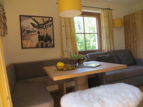 a living room with a couch and a table at Gästehaus Pfister Maria in Hippach