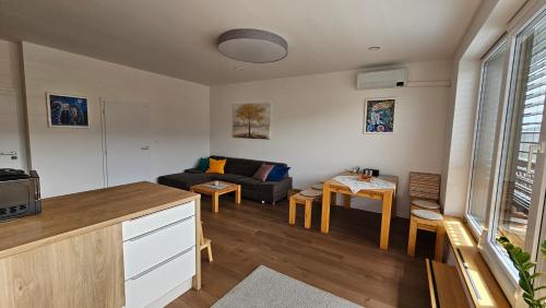 a living room with a couch and a table at Penthouse apartmán Minerál B-4 in Bardejovské Kúpele