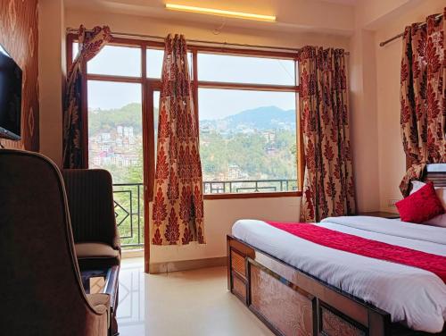 a bedroom with a bed and a large window at The Aston Hills - Majestic Mountain View in Shimla