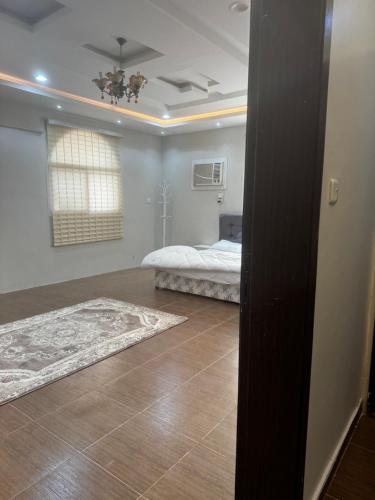 a bedroom with a bed and a rug on the floor at Alamjed Residence in Mecca