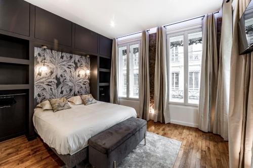 une chambre avec un lit et une grande fenêtre dans l'établissement Les Jacobins, hypercentre, à Lyon