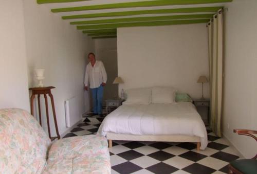 a woman standing in a room with two beds at Grande Maison - Bourg de Vatan in Vatan