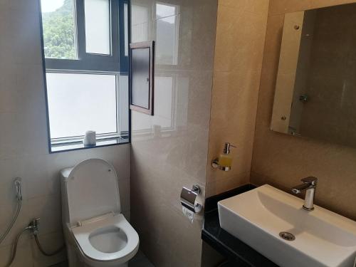 a bathroom with a toilet and a sink at Urban Boutique Hotel Pokhara in Pokhara