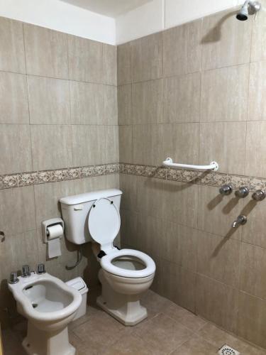 a bathroom with a toilet and a bidet at Casa de Myri in Villa Carlos Paz