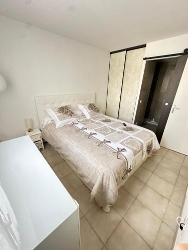 a white bedroom with a large bed in it at Appartement sans mauvaise surprises (2) in Juan-les-Pins