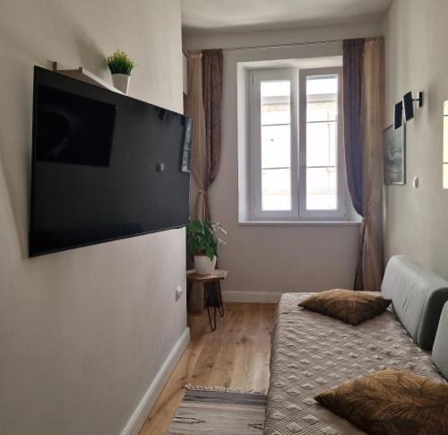 a living room with a couch and a window at Old Town Apartment in Omiš