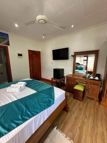 Ένα ή περισσότερα κρεβάτια σε δωμάτιο στο Benjamine's Guesthouse