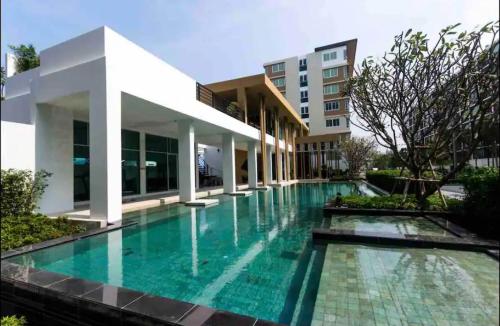 a swimming pool in front of a building at "500m from Beach Modern Residence" in Hua Hin