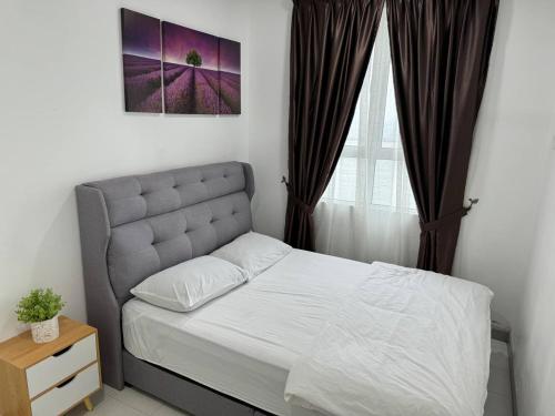 a bedroom with a bed and a window at D'CIELLA Homes- Sea View, Drawbridge & KTCC Mall in Kuala Terengganu