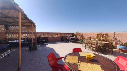 un patio con mesa y sillas en Hostel Afgo Rooftop en Ouarzazate