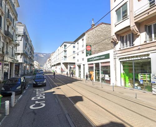 a city street with cars parked on the side of the road at Excellent T2 - 5min Gare & HyperCentre in Grenoble