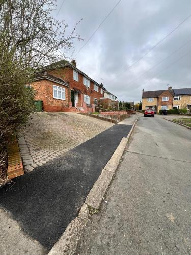 an empty street in front of a brick house at Steyn Guest Lodge in Buckinghamshire