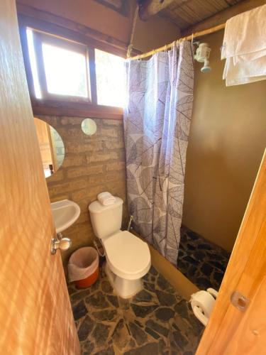 a bathroom with a toilet and a sink at Mirkeland- Cabaña in Ráquira