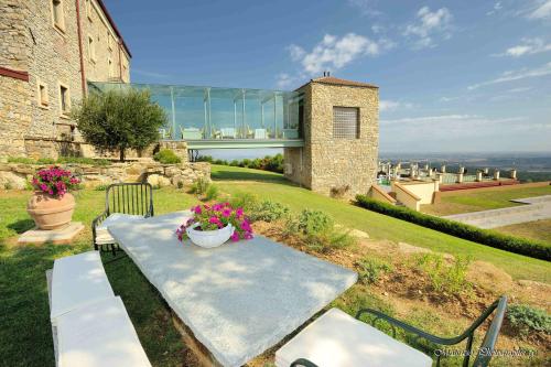 a table and chairs sitting on top of a house at Relais La Colombara Spa & Wellness in Travo