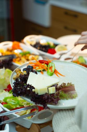 a plate of food on a table with vegetables and cheese at KUCA URLA in Urla