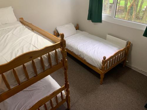 two bunk beds in a room with a window at L and A Lodges in Port Talbot