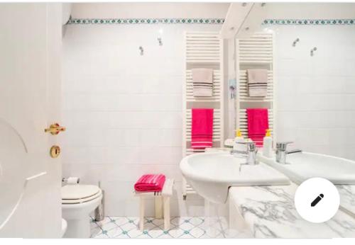 a white bathroom with a sink and a toilet at Cozy room in Palazzo Magnalbò in Macerata