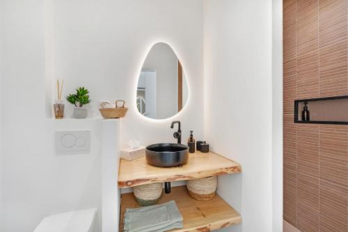 a bathroom with a sink and a mirror at My little Port Grimaud in Grimaud