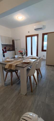 a dining room with a table and chairs at Macchialuru Home & Relax in Erchie