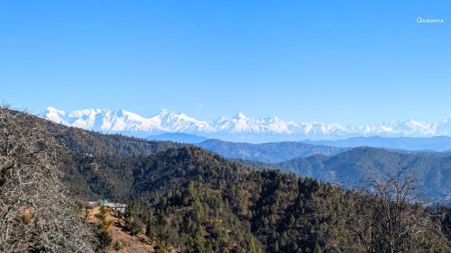 a mountain view with snow covered mountains in the distance at Shoonya x Aranya Agosh - Letibunga Mukteshwar in Mukteswar