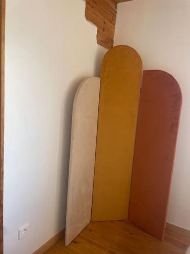 two surfboards leaning up against a wall at Chalet in Tasso