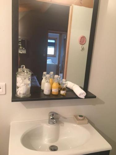 a bathroom sink with a large mirror above it at Chalet in Tasso