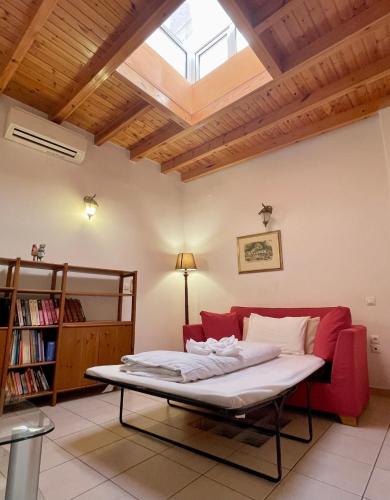a room with a bed and a couch and a window at Odyssey House in Chania