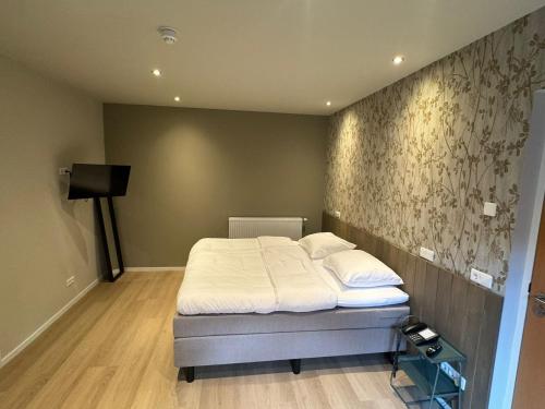 Postel nebo postele na pokoji v ubytování Hotel Bemelmans