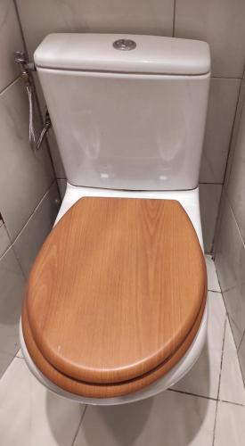 a toilet with a wooden seat in a bathroom at Studio Paris in Paris