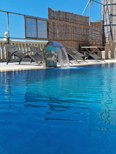 a swimming pool with a fountain in front of a building at Amazing Villa With Large Private Swimming Pool in Tangier