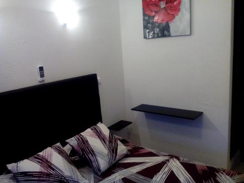 a bedroom with a bed and a table in it at Residência Matos Pereira in Vila Real de Santo António