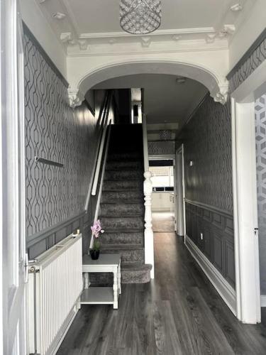 a hallway with stairs and a stair case at No. 206 - Spacious 5 Bed in Liverpool